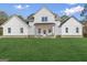 A modern farmhouse with a symmetrical facade and expansive green lawn at 1045 E Lake Road, Mcdonough, GA 30252