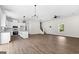 Spacious living area connecting to the kitchen with hardwood floors and white walls at 1045 E Lake Road, Mcdonough, GA 30252