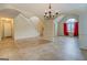 Living room with tile floors, a chandelier, and an archway leading to the staircase at 477 Harvick Cir, Stockbridge, GA 30281