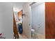 Powder room with tiled floor, standard toilet, blue and white striped wallpaper, next to the laundry room at 75 Antioch Rd, Mcdonough, GA 30252