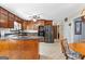 Well-lit kitchen with dark wood cabinets, granite countertops, and stainless steel appliances at 75 Antioch Rd, Mcdonough, GA 30252