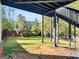 A spacious backyard featuring lush greenery, a wooden fence, and the framework of the above-ground deck at 109 Faversham Dr, Mcdonough, GA 30252