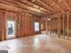 Unfinished basement featuring exposed wood framework and a walk-out door, offering potential for customization at 109 Faversham Dr, Mcdonough, GA 30252
