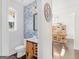 Cozy bathroom with wood vanity and blue floral wallpaper; bright, natural light at 109 Faversham Dr, Mcdonough, GA 30252