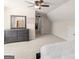 Spacious bedroom with sloped ceilings, carpet, and a wooden dresser with mirror at 109 Faversham Dr, Mcdonough, GA 30252