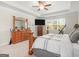Cozy bedroom with natural light, ceiling fan, and classic wooden furniture at 109 Faversham Dr, Mcdonough, GA 30252