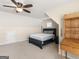 Bright bedroom featuring sloped ceilings, ceiling fan, carpet, and a writing desk at 109 Faversham Dr, Mcdonough, GA 30252