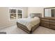 Cozy bedroom featuring carpet flooring, natural light from a window, and a matching dresser at 109 Faversham Dr, Mcdonough, GA 30252