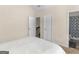 Bedroom view showcasing carpeted floor, doors, and access to an adjacent bathroom at 109 Faversham Dr, Mcdonough, GA 30252