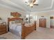 Primary bedroom with tray ceilings, ceiling fan, and natural light, inviting ambiance at 109 Faversham Dr, Mcdonough, GA 30252