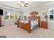 Comfortable bedroom featuring a large bed, ceiling fan, and bright natural light at 109 Faversham Dr, Mcdonough, GA 30252