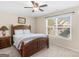 Bedroom with wooden bed frame, side table, and a window for natural light at 109 Faversham Dr, Mcdonough, GA 30252