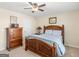 Bedroom featuring a bed with a wooden frame and a dresser at 109 Faversham Dr, Mcdonough, GA 30252