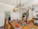 Beautiful dining room with wood table set for a meal and modern lighting fixture at 109 Faversham Dr, Mcdonough, GA 30252