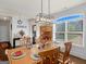 Dining room boasting a wood table set for a meal, hutch, and a modern lighting fixture at 109 Faversham Dr, Mcdonough, GA 30252