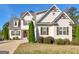 Charming two-story home with tan siding, brown shutters, manicured landscaping, and a welcoming entrance at 109 Faversham Dr, Mcdonough, GA 30252