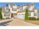 Lovely two-story home featuring a three car garage, tan siding, and a well-maintained lawn at 109 Faversham Dr, Mcdonough, GA 30252