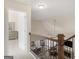 Hallway featuring a wooden railing with views of the dining room and living room below at 109 Faversham Dr, Mcdonough, GA 30252