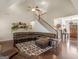 Spacious living room featuring a large sectional sofa, hardwood floors, and a staircase at 109 Faversham Dr, Mcdonough, GA 30252