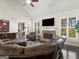 Open living room with fireplace and large windows, offering plenty of natural light at 109 Faversham Dr, Mcdonough, GA 30252