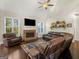 Inviting living room showcasing a brick fireplace, large windows, and comfortable seating at 109 Faversham Dr, Mcdonough, GA 30252