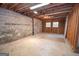 Unfinished basement offers potential for customization, with exposed brick and wooden framing at 250 Devilla Trce, Fayetteville, GA 30214