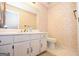 Cozy bathroom features a vanity with white cabinets and a large mirror with elegant wallpaper at 250 Devilla Trce, Fayetteville, GA 30214
