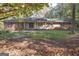 Charming brick and wood home with a well-manicured front lawn and mature trees at 250 Devilla Trce, Fayetteville, GA 30214