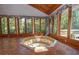 Bright sunroom features a large hot tub and expansive windows overlooking the wooded backyard at 250 Devilla Trce, Fayetteville, GA 30214