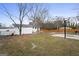 Spacious backyard featuring mature trees, patio, and partial fencing at 2827 Somerton Dr, Morrow, GA 30260