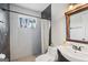 Bathroom featuring tiled walls, shower, toilet, and sink with wood trim at 2827 Somerton Dr, Morrow, GA 30260