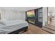 Bedroom with built-in TV, fireplace, light hardwood floors, closet space and an accent wall at 2827 Somerton Dr, Morrow, GA 30260