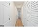 Bright hallway with wood floors, white doors and trim, with lots of storage space at 2827 Somerton Dr, Morrow, GA 30260