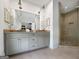 Bright bathroom featuring a glass shower, double vanity, and tile floors at 9135 Selborne Ln, Chattahoochee Hills, GA 30268