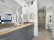 Bright bathroom featuring a glass shower, double vanity, and tile floors at 9135 Selborne Ln, Chattahoochee Hills, GA 30268