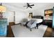 Bright bedroom featuring ceiling fan, two sitting chairs, carpeted floors and neutral color palette at 9135 Selborne Ln, Chattahoochee Hills, GA 30268