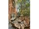 Outdoor courtyard with brick walls, rustic wooden furniture and shade trees, great for entertaining at 9135 Selborne Ln, Chattahoochee Hills, GA 30268