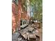 Outdoor courtyard with brick walls, rustic wooden furniture and shade trees, great for entertaining at 9135 Selborne Ln, Chattahoochee Hills, GA 30268