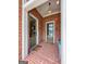 Brick entrance with two green doors, one marked 913, and a small blue bench at 9135 Selborne Ln, Chattahoochee Hills, GA 30268