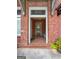 Inviting entryway with brick floor, front door with transom, and house number display at 9135 Selborne Ln, Chattahoochee Hills, GA 30268