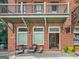 Charming two-story brick building featuring a wine shop, balcony, and outdoor seating at 9135 Selborne Ln, Chattahoochee Hills, GA 30268