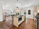 Spacious kitchen featuring an island with a breakfast bar, stainless steel appliances and open floor plan at 9135 Selborne Ln, Chattahoochee Hills, GA 30268
