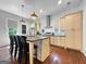 Well-appointed kitchen with a large island, stainless steel range hood, and stylish pendants at 9135 Selborne Ln, Chattahoochee Hills, GA 30268