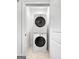 Conveniently located laundry room with stacked washer and dryer units at 9135 Selborne Ln, Chattahoochee Hills, GA 30268