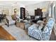 Open-concept living room with hardwood floors, stylish seating, and views to other living areas at 9135 Selborne Ln, Chattahoochee Hills, GA 30268