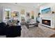 Inviting living room with fireplace, stylish furniture, and plenty of natural light at 9135 Selborne Ln, Chattahoochee Hills, GA 30268