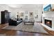 Cozy living room with a fireplace, hardwood floors, and stylish decor at 9135 Selborne Ln, Chattahoochee Hills, GA 30268