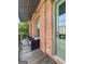 Outdoor porch with seating area and brick exterior at 9135 Selborne Ln, Chattahoochee Hills, GA 30268