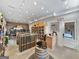 Beautiful commercial wine cellar with oak wine racks, refrigerated display, and a brick-lined view of a lounge room at 9135 Selborne Ln, Chattahoochee Hills, GA 30268