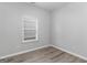 Bedroom with a window with white blinds, gray paint and wood-look flooring at 184 Parkview Place Dr, Mcdonough, GA 30253